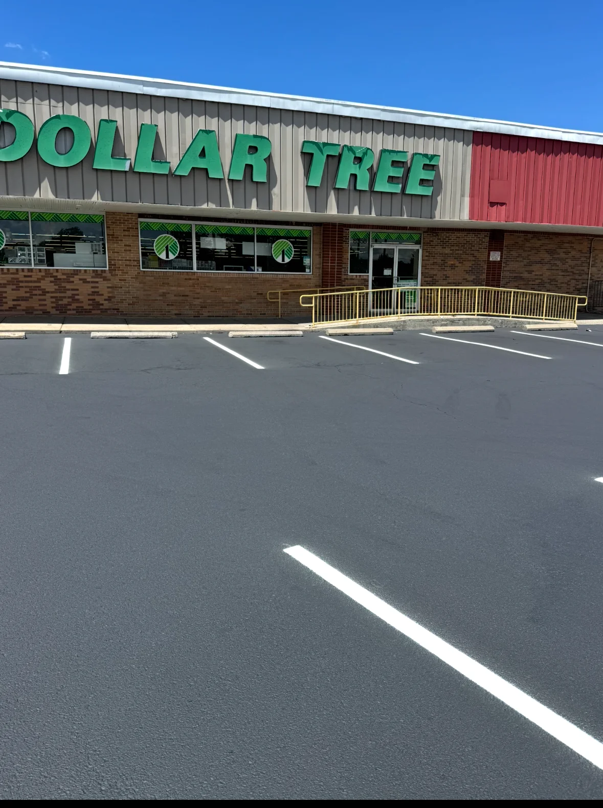 Freshly striped parking lot with white lines at Dollar Tree retail storefront